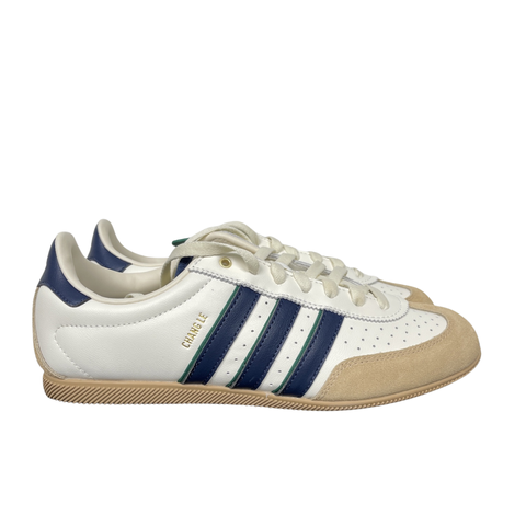 Shop adidas Chang Le LA1355 in Core White and Warm Sandstone with perforated tumbled leather, double-stitched T-toe detailing and a low-profile retro silhouette.