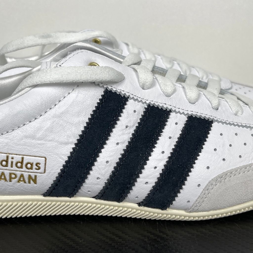 Shop adidas Japan IH5489 in Cloud White, Core Black and Gold Metallic with a leather upper, double-stitched T-toe and archival 1964 low-profile styling.
