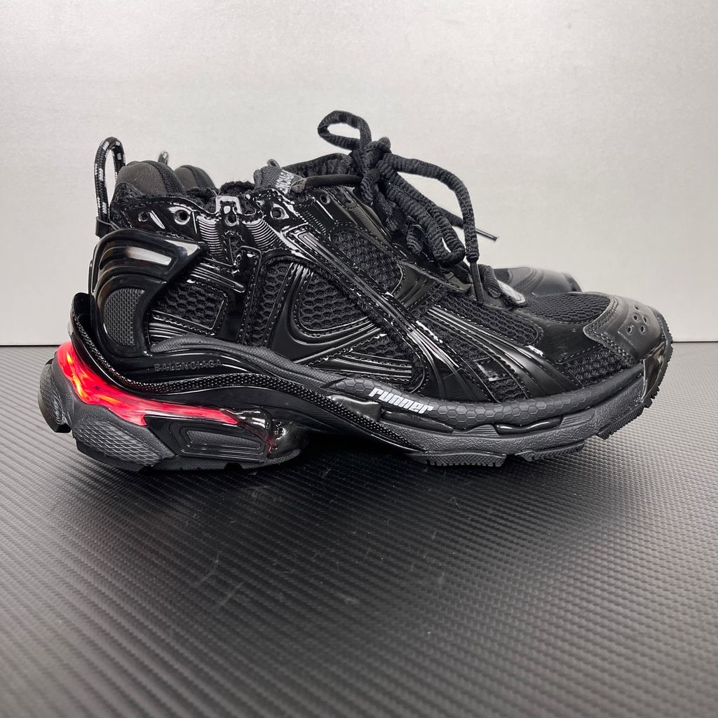 Shop Balenciaga Runner LED 853225 WRNLD 1000 in Black with layered technical construction, worn-out detailing, integrated LED sole and USB charging cable.