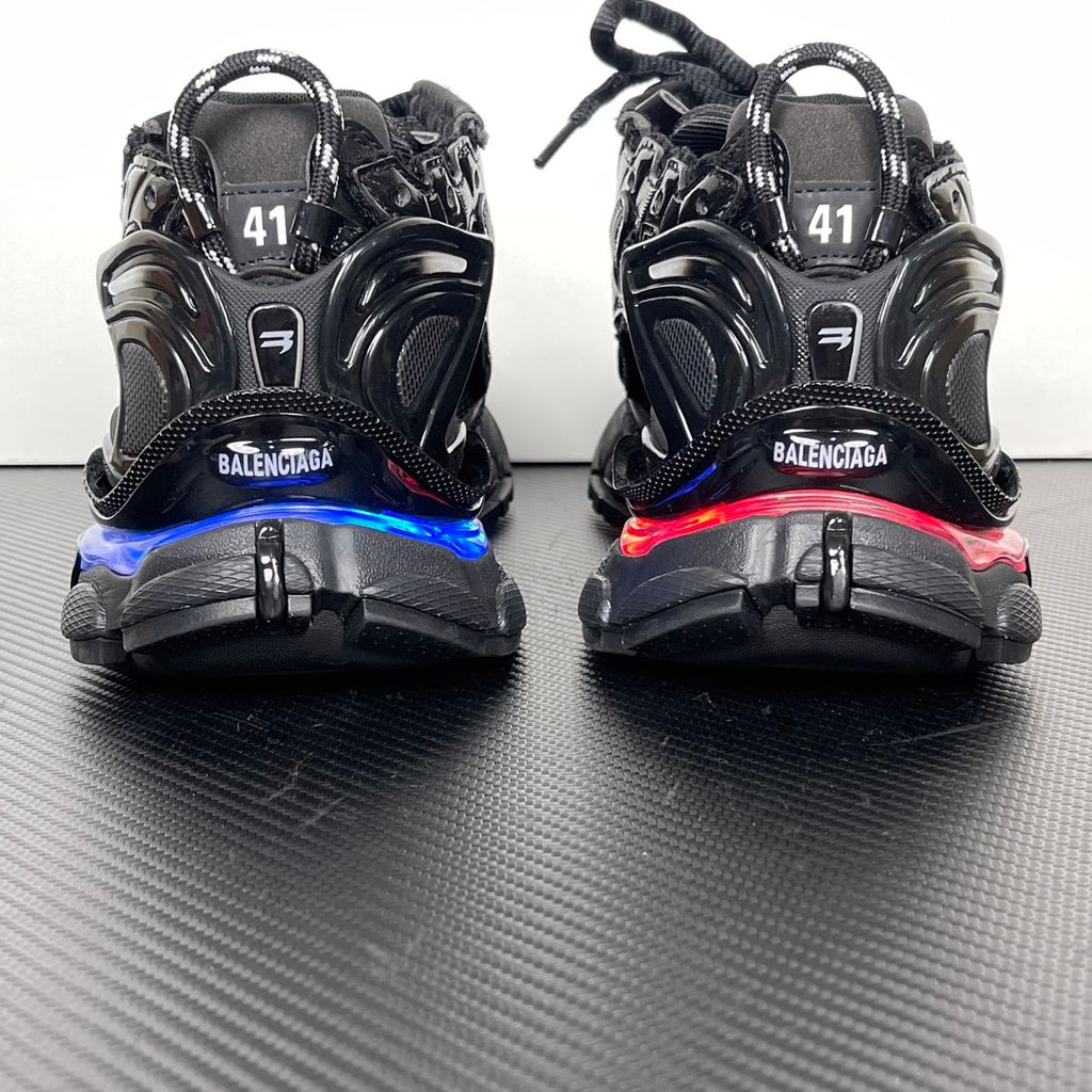 Shop Balenciaga Runner LED 853225 WRNLD 1000 in Black with layered technical construction, worn-out detailing, integrated LED sole and USB charging cable.
