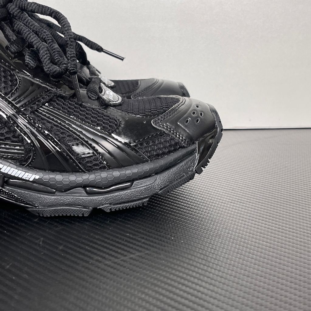 Shop Balenciaga Runner LED 853225 WRNLD 1000 in Black with layered technical construction, worn-out detailing, integrated LED sole and USB charging cable.
