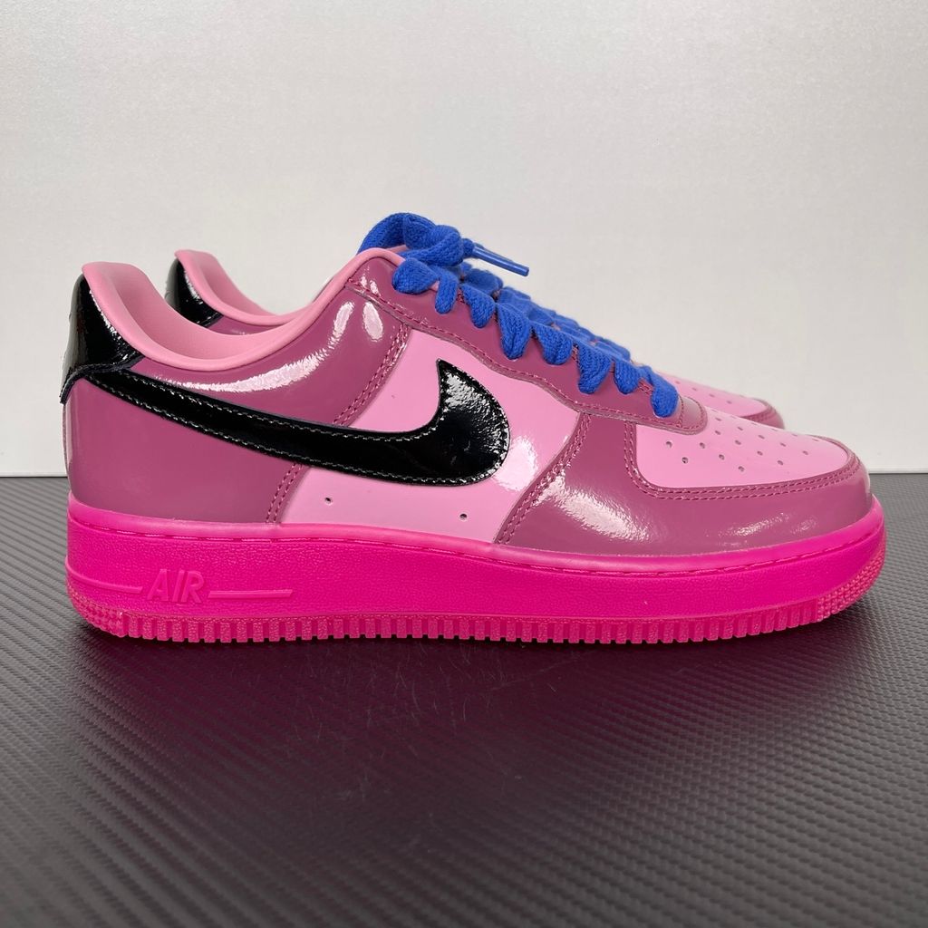 Shop Nike Air Force 1 Low IO4489-600 in Pink Cooler, Mulberry Rose, Hyper Blue and Black with glossy leather styling, Nike Air cushioning and rubber traction.