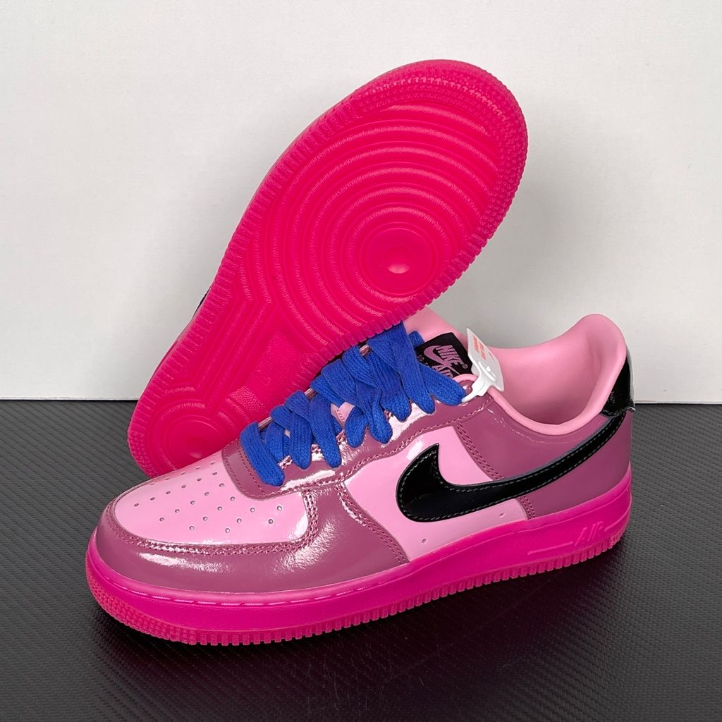 Shop Nike Air Force 1 Low IO4489-600 in Pink Cooler, Mulberry Rose, Hyper Blue and Black with glossy leather styling, Nike Air cushioning and rubber traction.