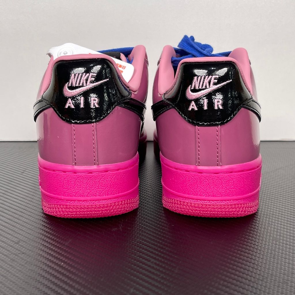 Shop Nike Air Force 1 Low IO4489-600 in Pink Cooler, Mulberry Rose, Hyper Blue and Black with glossy leather styling, Nike Air cushioning and rubber traction.