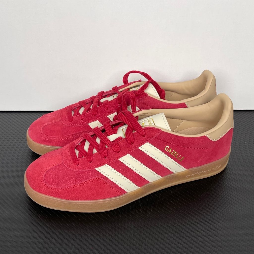 Shop adidas Gazelle Indoor KI2251 in Team Victory Red, Warm Vanilla and Magic Beige with leather upper, classic 3-Stripes, gold Gazelle branding and rubber outsole.