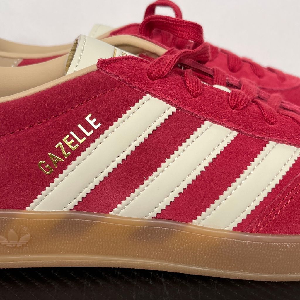 Shop adidas Gazelle Indoor KI2251 in Team Victory Red, Warm Vanilla and Magic Beige with leather upper, classic 3-Stripes, gold Gazelle branding and rubber outsole.