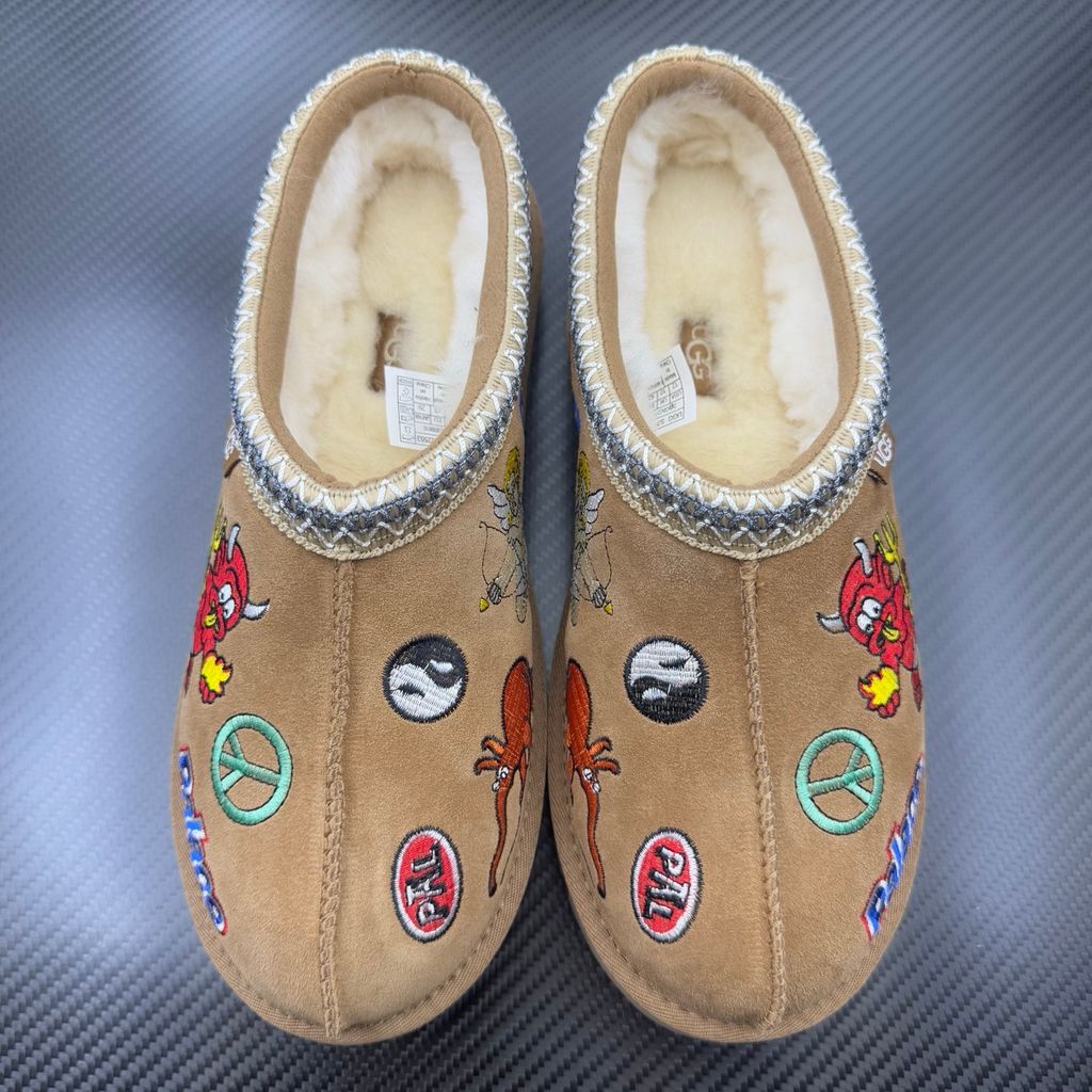 Shop UGG x Palace Tasman Slipper 1157290-CHE in Chestnut suede with embroidered Palace graphics, braided collar, plush lining, EVA midsole and Treadlite outsole.
