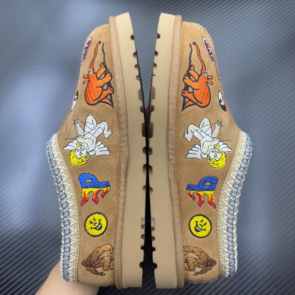 Shop UGG x Palace Tasman Slipper 1157290-CHE in Chestnut suede with embroidered Palace graphics, braided collar, plush lining, EVA midsole and Treadlite outsole.