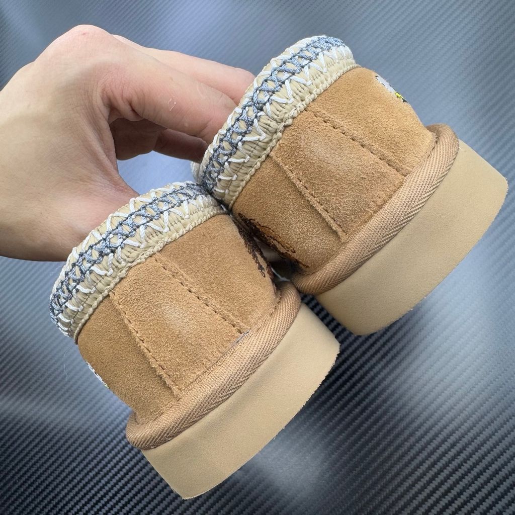 Shop UGG x Palace Tasman Slipper 1157290-CHE in Chestnut suede with embroidered Palace graphics, braided collar, plush lining, EVA midsole and Treadlite outsole.