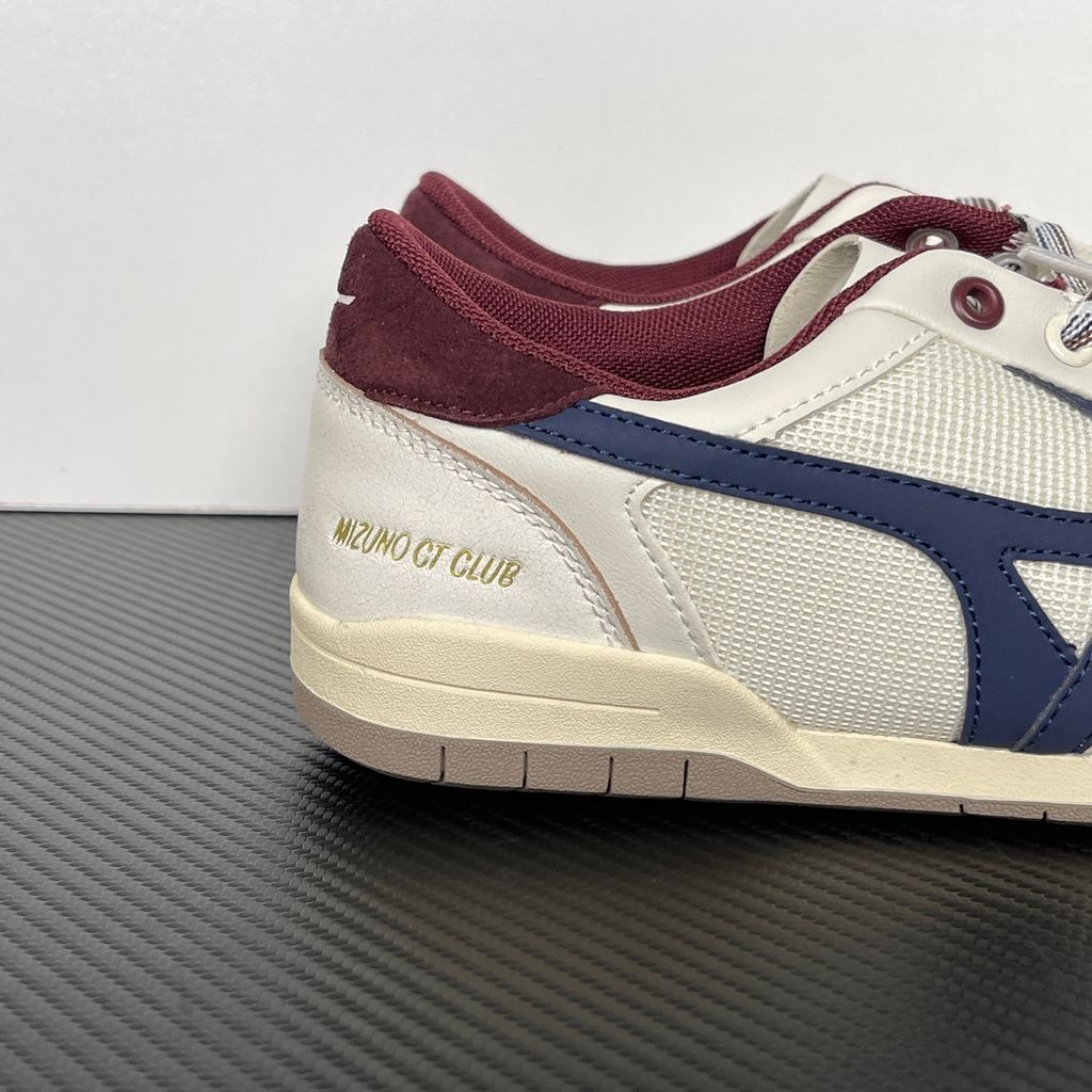 Shop Mizuno CT CLUB D1GH261010 in Light Beige, Navy and Burgundy with mixed textile and leather-based upper, retro court styling and low-top construction.