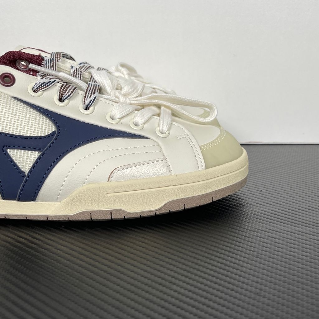 Shop Mizuno CT CLUB D1GH261010 in Light Beige, Navy and Burgundy with mixed textile and leather-based upper, retro court styling and low-top construction.