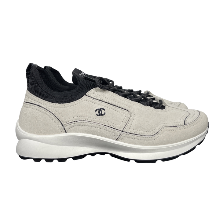 Shop CHANEL 26A Sneakers G47416 B25250 UC402 in White calfskin and suede calfskin with black Double-C detail and retro runner-inspired sole.