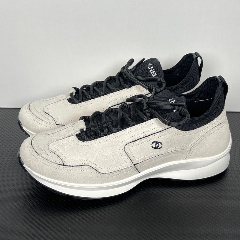 Shop CHANEL 26A Sneakers G47416 B25250 UC402 in White calfskin and suede calfskin with black Double-C detail and retro runner-inspired sole.