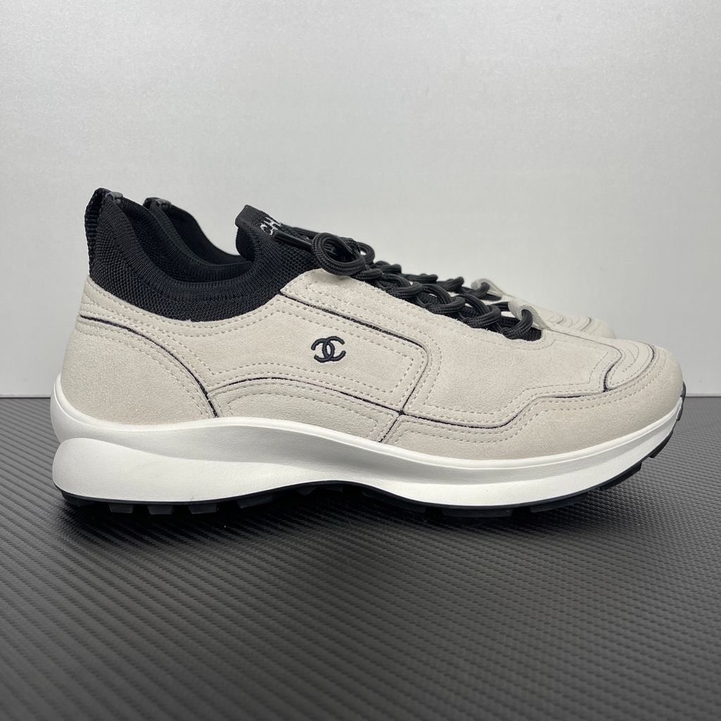 Shop CHANEL 26A Sneakers G47416 B25250 UC402 in White calfskin and suede calfskin with black Double-C detail and retro runner-inspired sole.