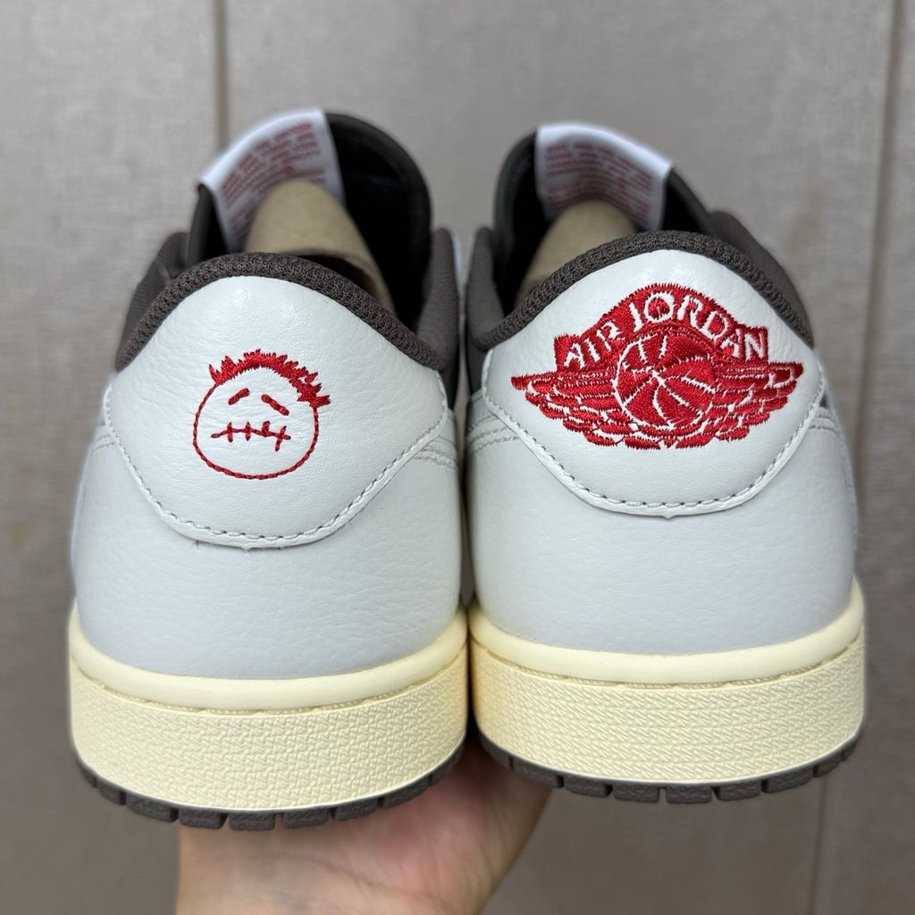 Shop Travis Scott x Air Jordan 1 Low OG Reverse Mocha DM7866-162 in Sail, Ridgerock and University Red with suede, leather, reverse Swoosh and Nike Air cushioning.
