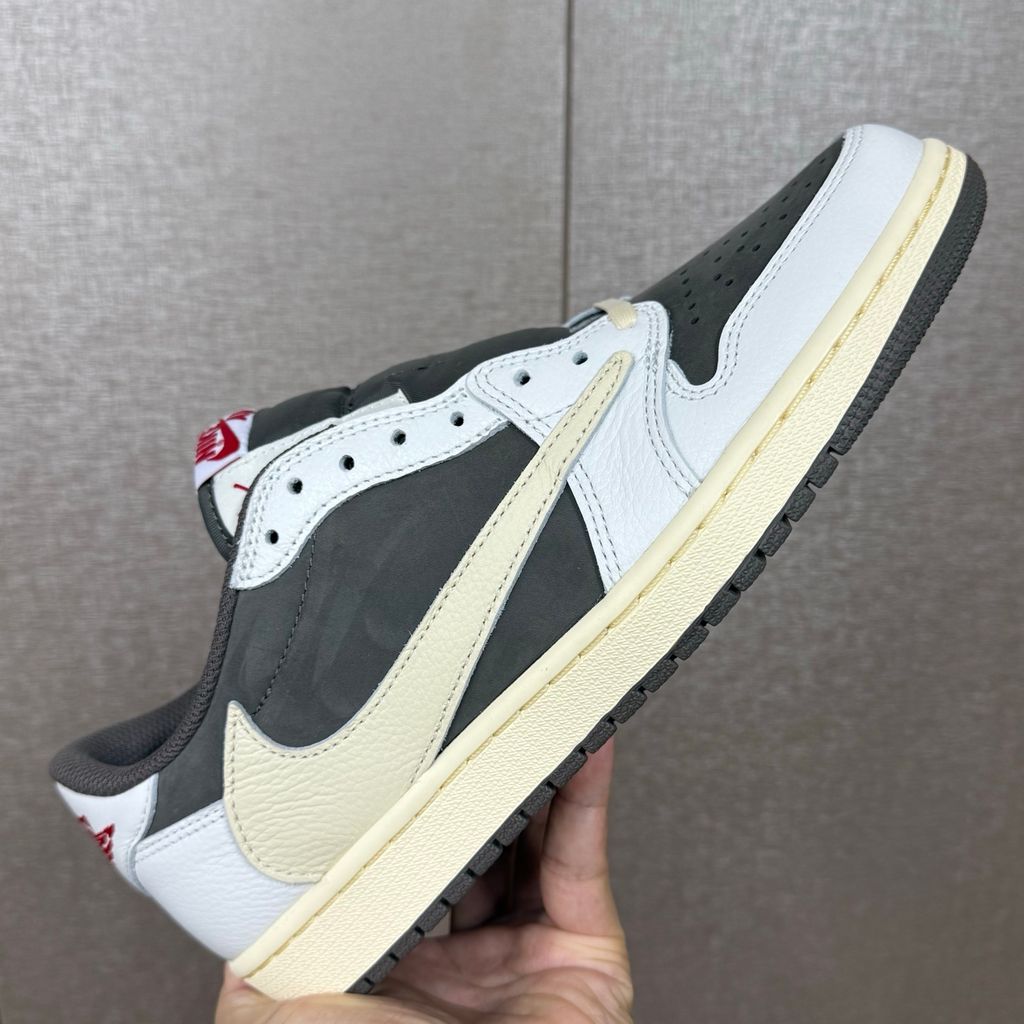 Shop Travis Scott x Air Jordan 1 Low OG Reverse Mocha DM7866-162 in Sail, Ridgerock and University Red with suede, leather, reverse Swoosh and Nike Air cushioning.
