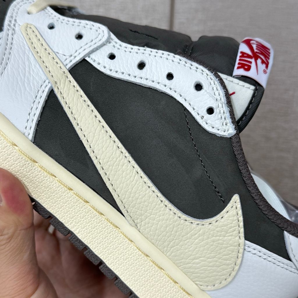 Shop Travis Scott x Air Jordan 1 Low OG Reverse Mocha DM7866-162 in Sail, Ridgerock and University Red with suede, leather, reverse Swoosh and Nike Air cushioning.