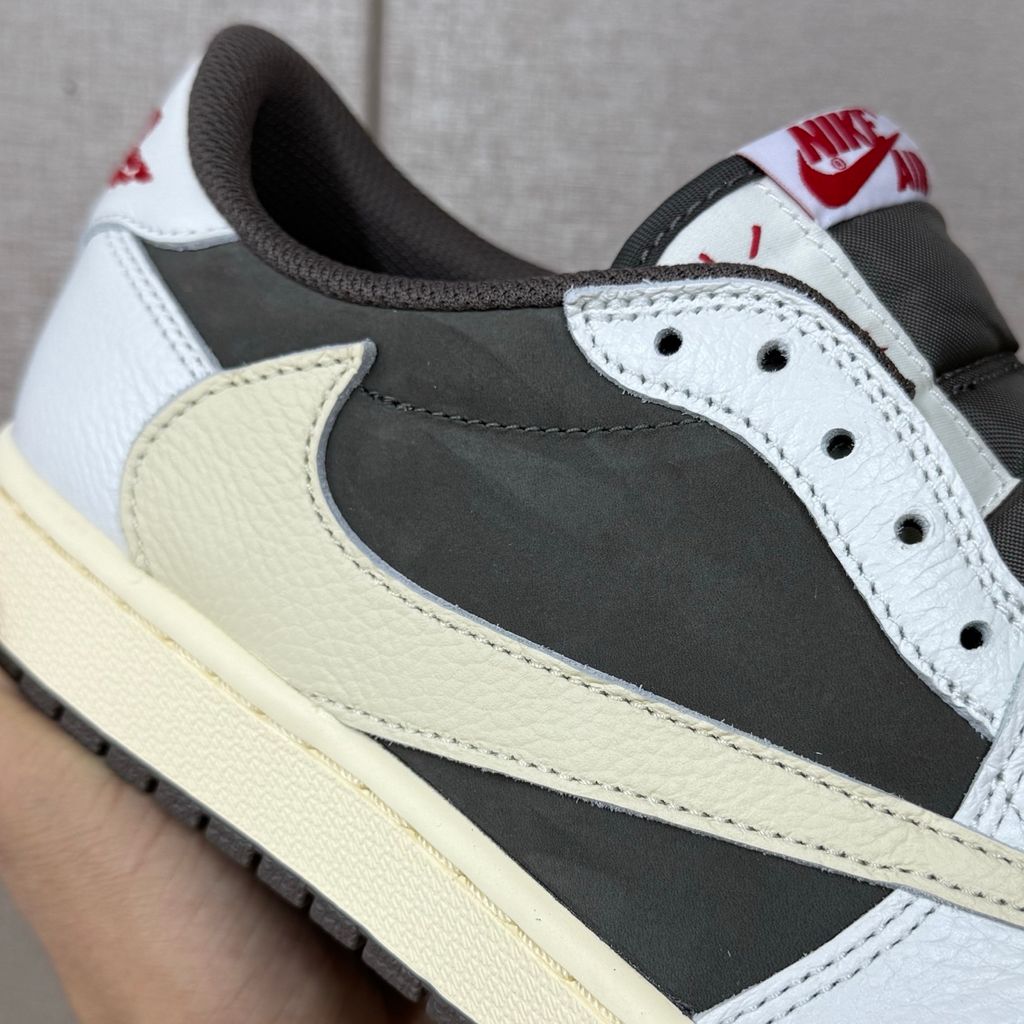 Shop Travis Scott x Air Jordan 1 Low OG Reverse Mocha DM7866-162 in Sail, Ridgerock and University Red with suede, leather, reverse Swoosh and Nike Air cushioning.