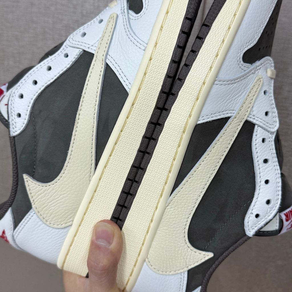 Shop Travis Scott x Air Jordan 1 Low OG Reverse Mocha DM7866-162 in Sail, Ridgerock and University Red with suede, leather, reverse Swoosh and Nike Air cushioning.