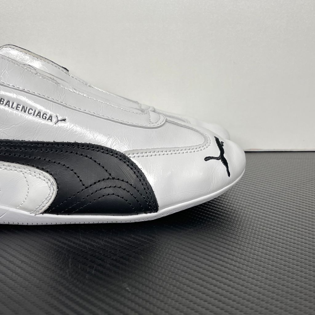 Balenciaga x PUMA Speedcat Leather 847148-WSDSB-9010 White Black Men's Slip-On Sneakers with White Cowskin Leather Upper, Black PUMA Formstrip, Debossed Balenciaga and PUMA Logos, Embroidered PUMA Cat Toe, Reflective Rear Pull Tab and Rubber Outsole