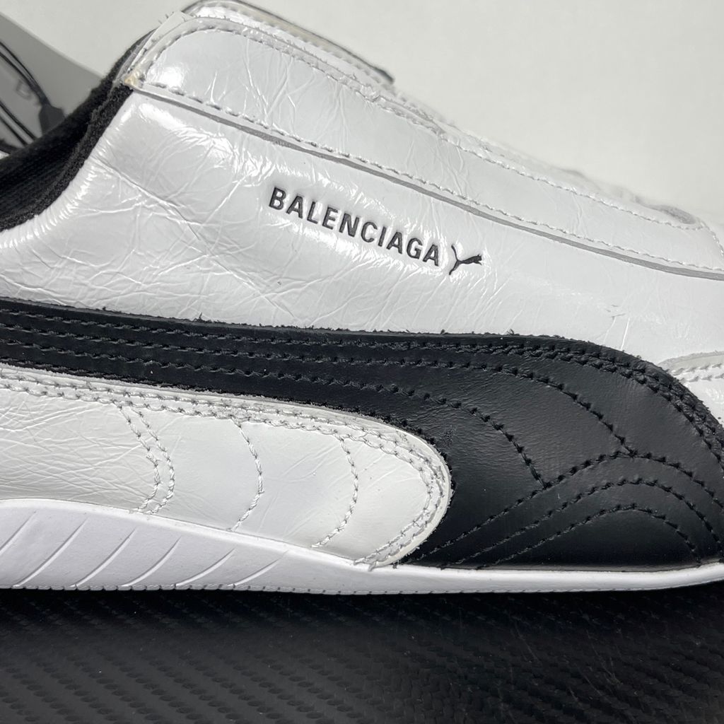 Balenciaga x PUMA Speedcat Leather 847148-WSDSB-9010 White Black Men's Slip-On Sneakers with White Cowskin Leather Upper, Black PUMA Formstrip, Debossed Balenciaga and PUMA Logos, Embroidered PUMA Cat Toe, Reflective Rear Pull Tab and Rubber Outsole