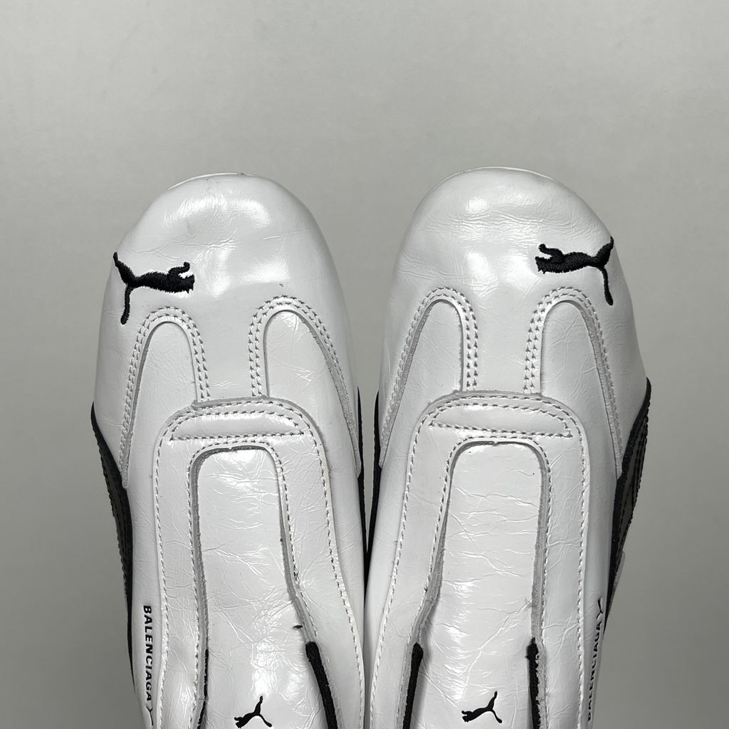 Balenciaga x PUMA Speedcat Leather 847148-WSDSB-9010 White Black Men's Slip-On Sneakers with White Cowskin Leather Upper, Black PUMA Formstrip, Debossed Balenciaga and PUMA Logos, Embroidered PUMA Cat Toe, Reflective Rear Pull Tab and Rubber Outsole
