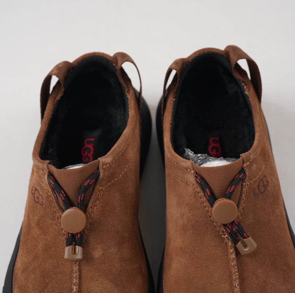 Verified against UGG's current 1179050-DKC Dark Chestnut Tasman Outpost product information, including waterproof suede, seam-sealed construction, 17mm UGGpure/UGGplush interior, Sugarcane EVA and White Spider Rubber outsole. UGG
