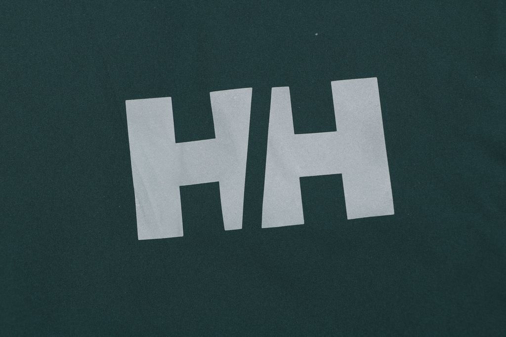 Helly Hansen ODIN side zip hooded softshell jacket green four way stretch grid fleece articulated sleeves adjustable helmet compatible hood sizes S-3XL