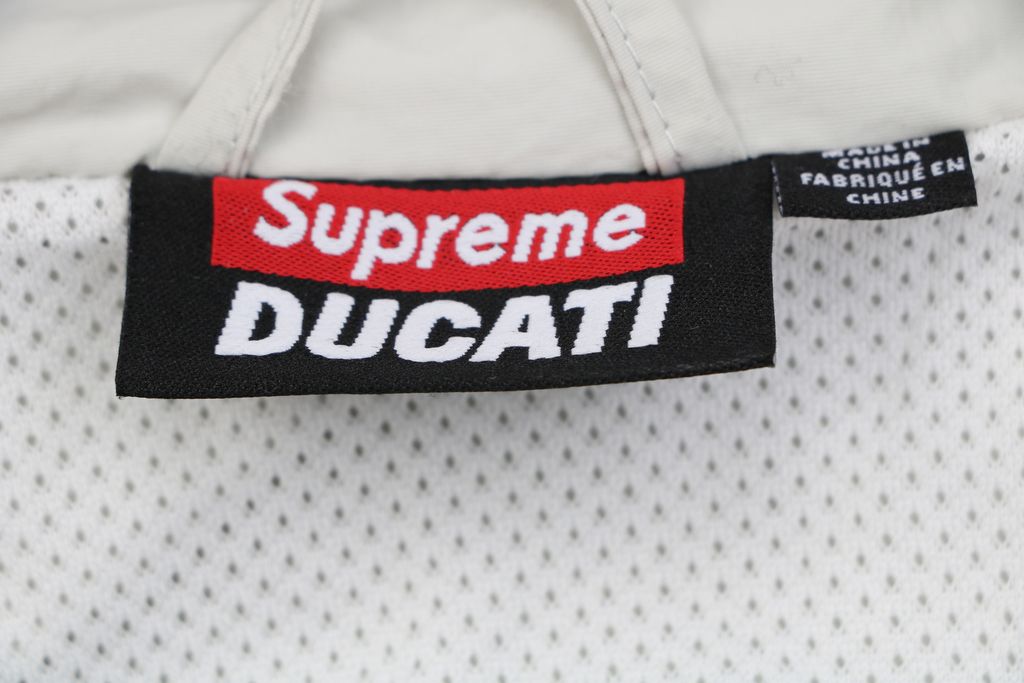 Supreme Ducati racing stand collar track jacket matte technical fabric breathable mesh lining 3D silicone logo metal plaque YKK zipper unisex sizes S-XL