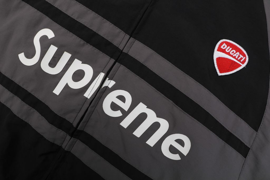 Supreme Ducati racing stand collar track jacket black matte technical fabric breathable mesh lining 3D silicone logo metal plaque YKK zipper unisex sizes S-XL