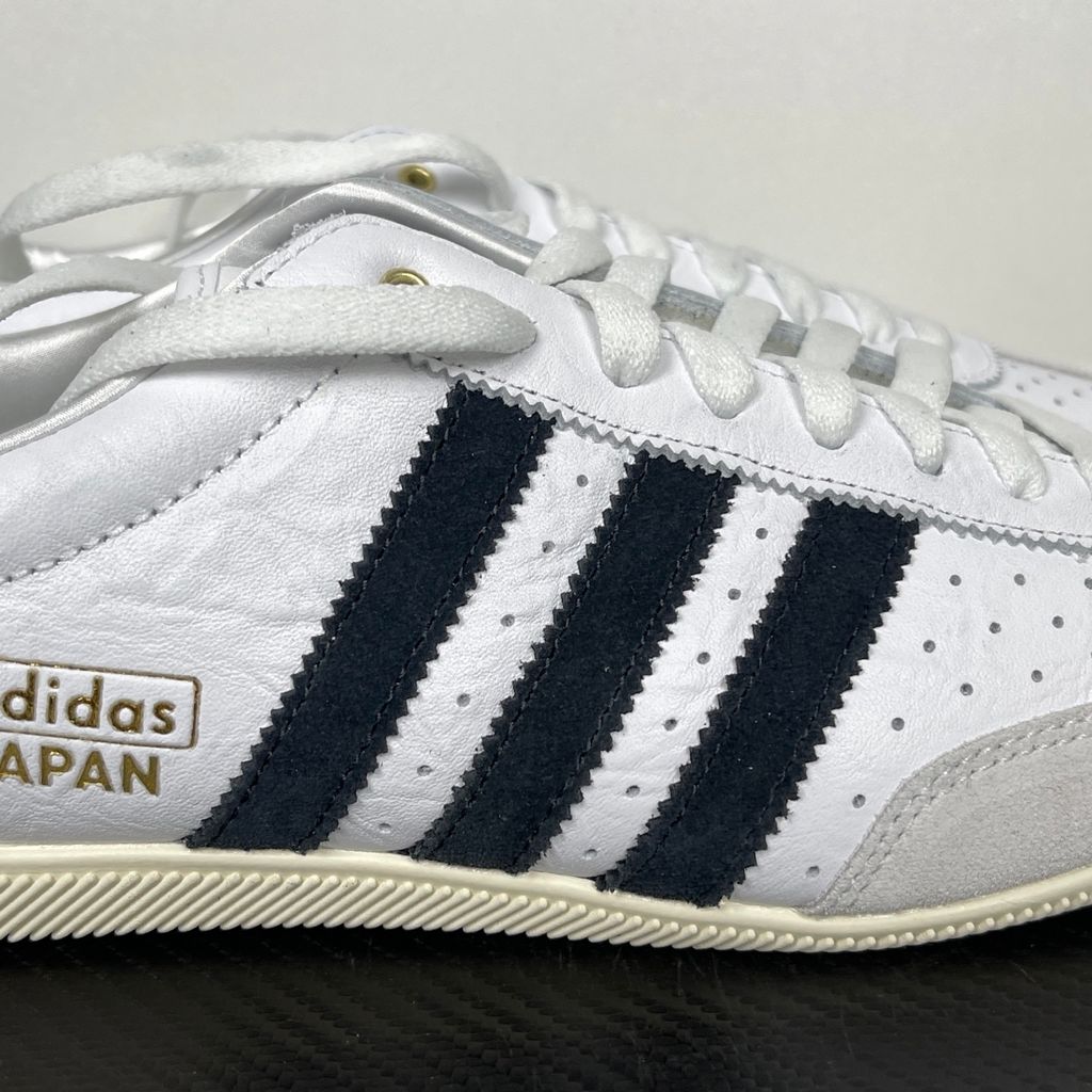 Shop adidas Japan IH5489 in Cloud White, Core Black and Gold Metallic with a leather upper, double-stitched T-toe and archival 1964 low-profile styling.