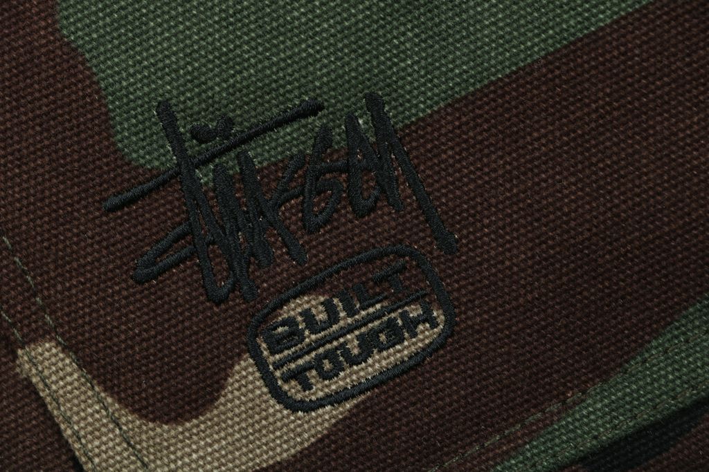 Stussy four pocket tonal jacquard embroidered work jacket structured fabric chest letter logo relaxed drop shoulder unisex utility outerwear sizes S-XL
