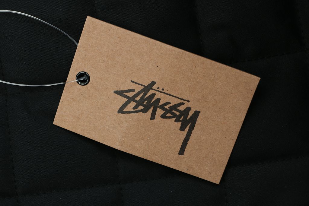 Stussy four pocket tonal jacquard embroidered work jacket structured fabric chest letter logo relaxed drop shoulder unisex utility outerwear sizes S-XL