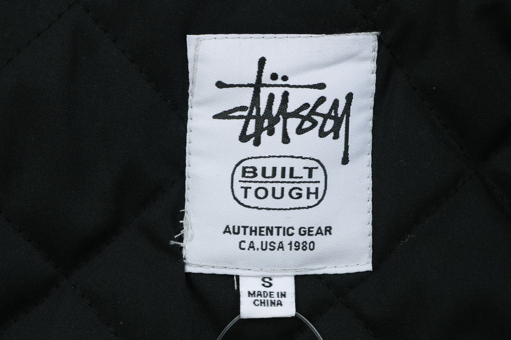 Stussy four pocket tonal jacquard embroidered work jacket structured fabric chest letter logo relaxed drop shoulder unisex utility outerwear sizes S-XL