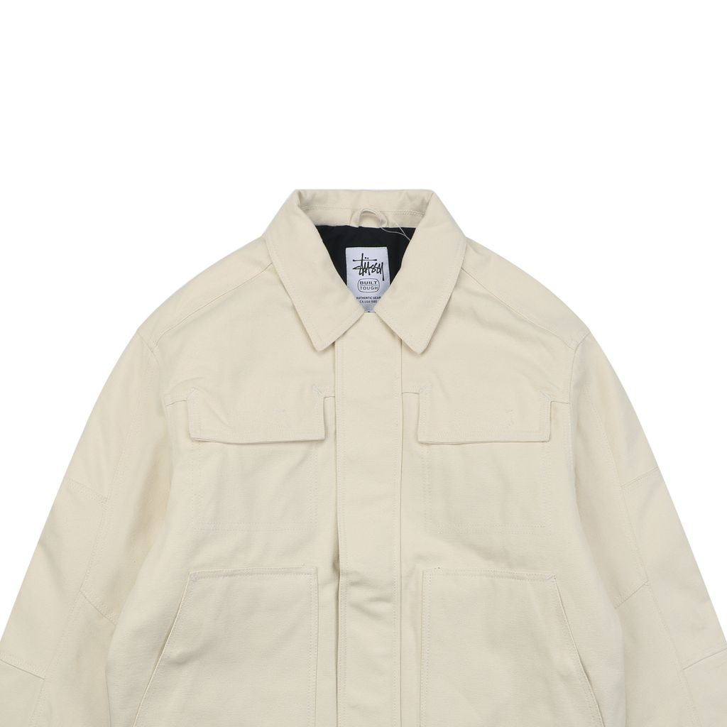 Stussy four pocket tonal jacquard embroidered work jacket beige structured fabric chest letter logo relaxed drop shoulder unisex utility outerwear sizes S-XL