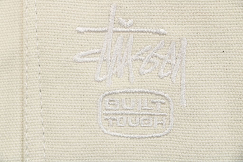 Stussy four pocket tonal jacquard embroidered work jacket beige structured fabric chest letter logo relaxed drop shoulder unisex utility outerwear sizes S-XL