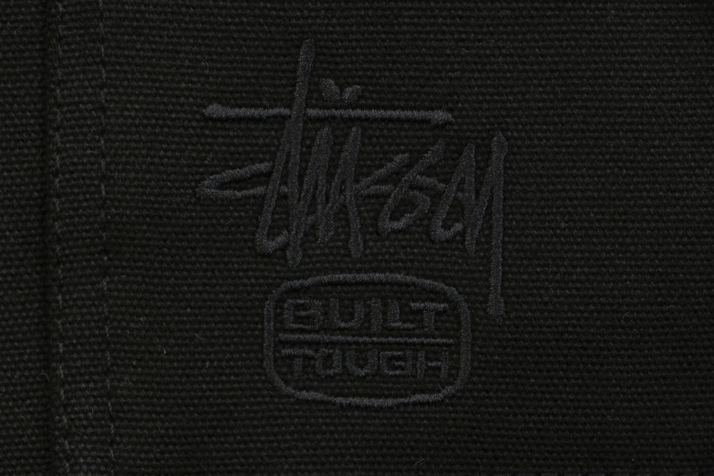 Stussy four pocket tonal jacquard embroidered work jacket black structured fabric chest letter logo relaxed drop shoulder unisex utility outerwear sizes S-XL
