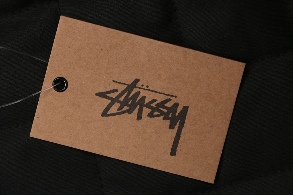 Stussy four pocket tonal jacquard embroidered work jacket black structured fabric chest letter logo relaxed drop shoulder unisex utility outerwear sizes S-XL