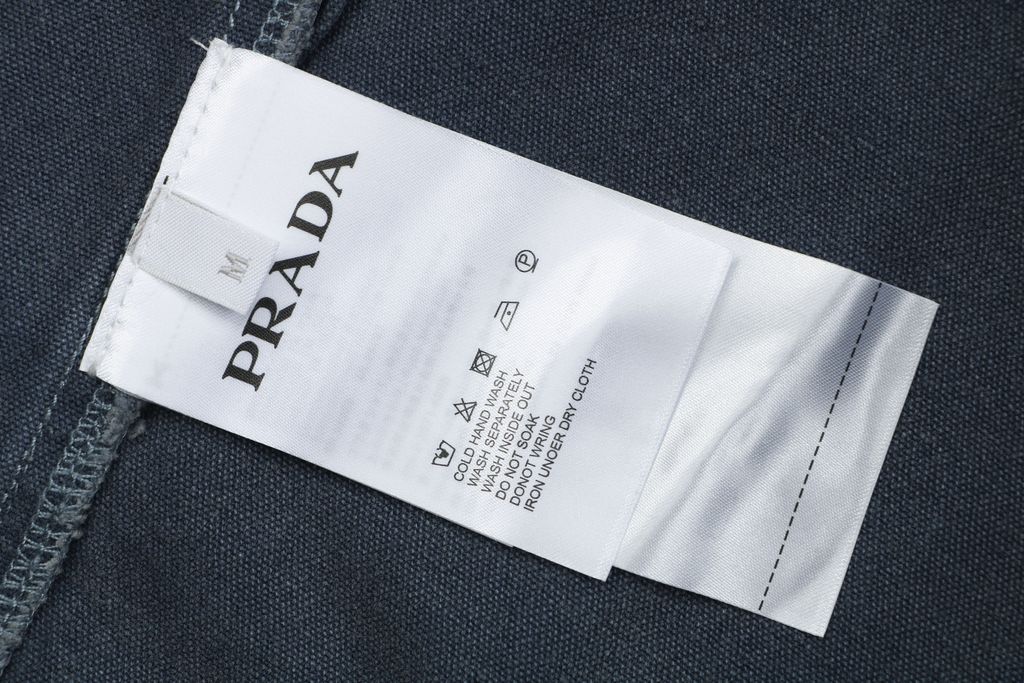 Prada washed triangle badge distressed utility jacket 100 percent polyester workwear fabric enzyme washed vintage faded finish sizes XS-L