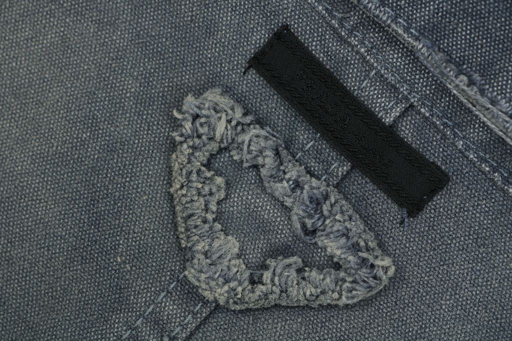 Prada washed triangle badge distressed utility jacket 100 percent polyester workwear fabric enzyme washed vintage faded finish sizes XS-L