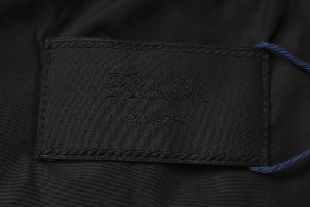 Prada triangle badge jacquard padded jacket recycled nylon logo fabric high density rayon lining 80g insulation custom hardware oversized fit sizes S-XL