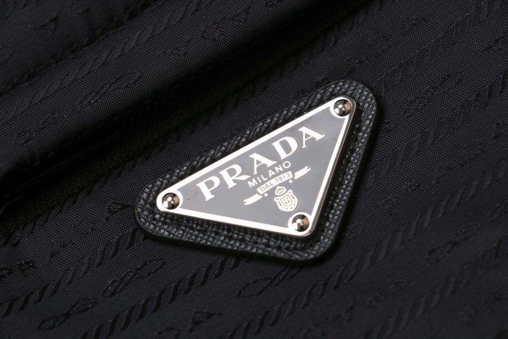 Prada triangle badge jacquard padded jacket recycled nylon logo fabric high density rayon lining 80g insulation custom hardware oversized fit sizes S-XL