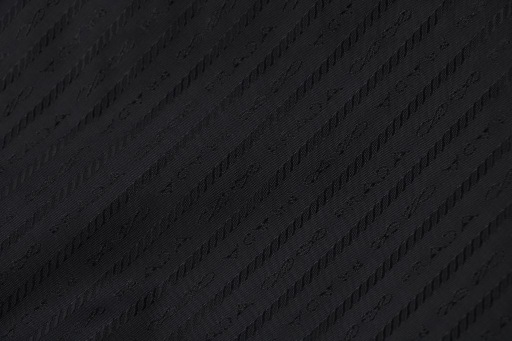 Prada triangle badge jacquard padded jacket recycled nylon logo fabric high density rayon lining 80g insulation custom hardware oversized fit sizes S-XL