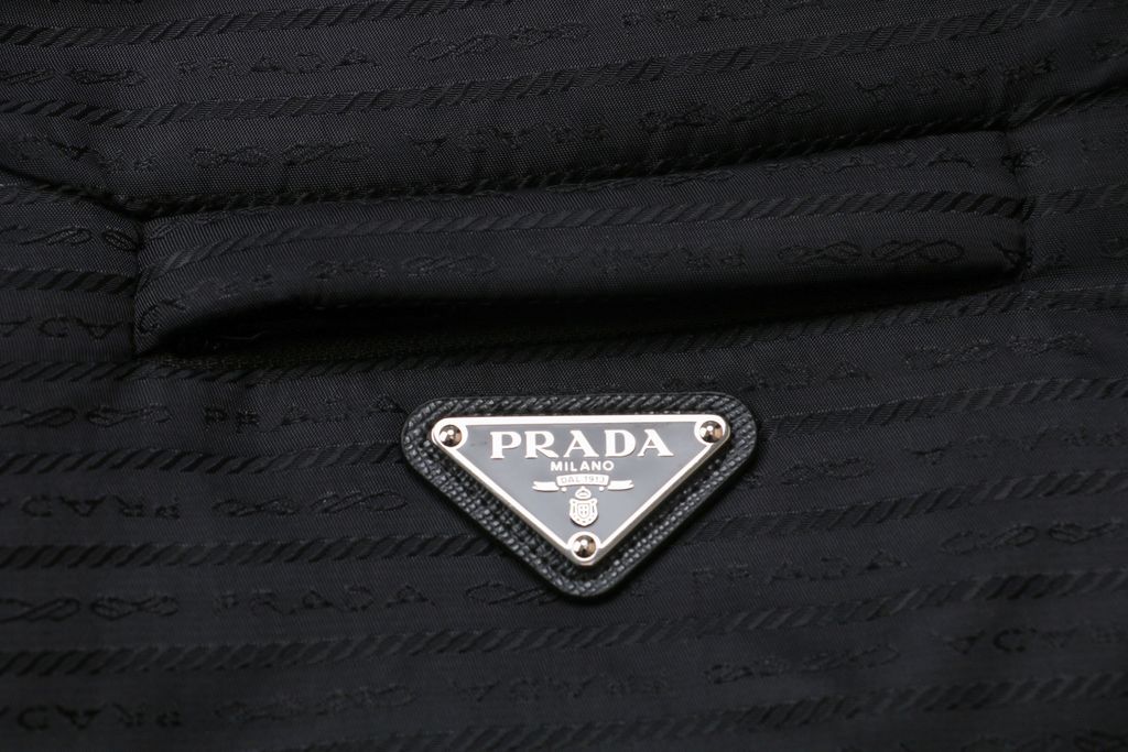 Prada triangle badge jacquard padded jacket recycled nylon logo fabric high density rayon lining 80g insulation custom hardware oversized fit sizes S-XL