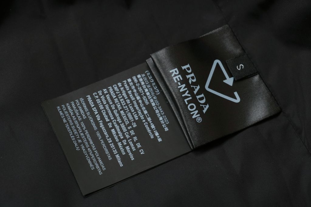Prada triangle badge jacquard padded jacket recycled nylon logo fabric high density rayon lining 80g insulation custom hardware oversized fit sizes S-XL