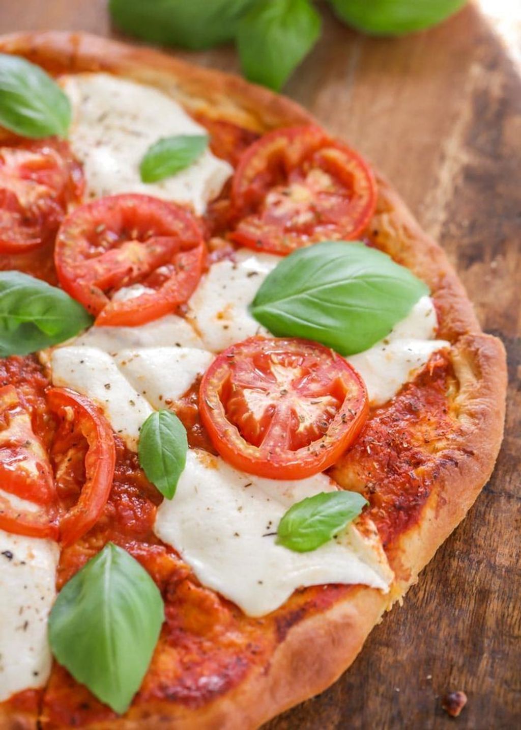 Margherita pizza stars fresh basil, mozzarella cheese, and the best ripe tomatoes_ It's simple, delicious, and light_