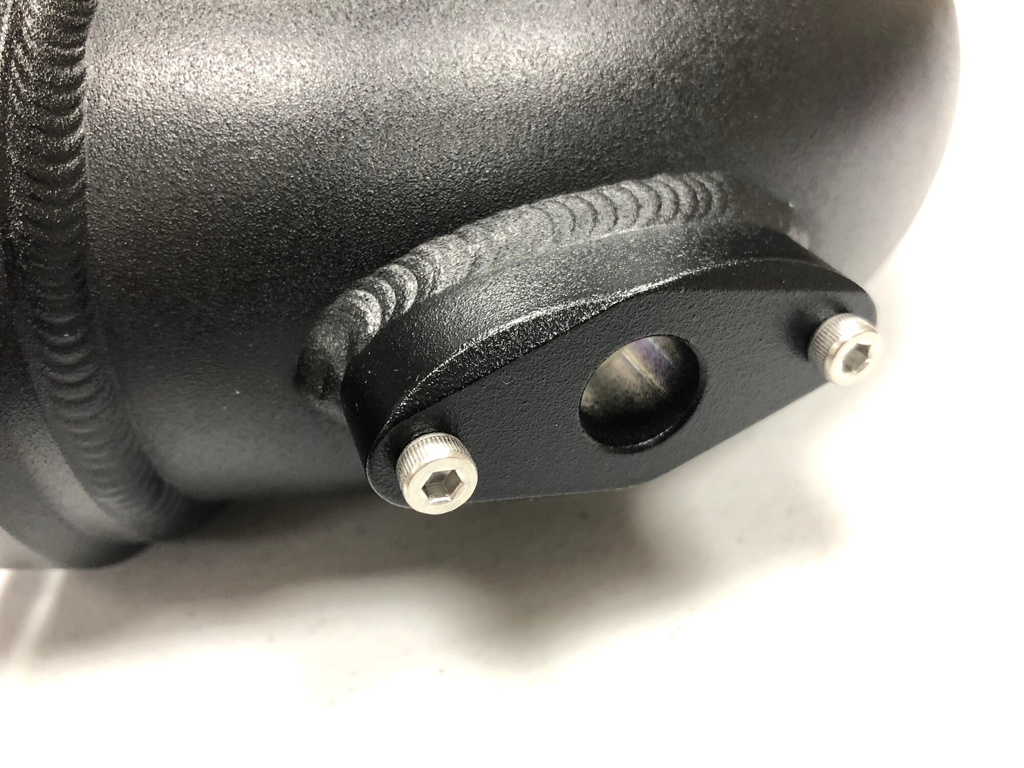 Close-up of CNC-machined throttle body flange on FTP N54 charge pipe