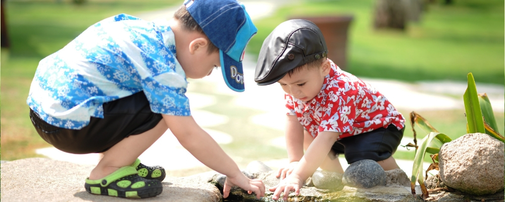 two young children playing together outdoors