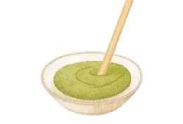 A small bowl of hay puree with a stirring stick