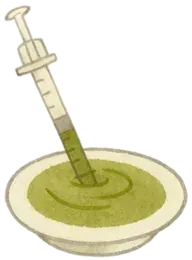 A bowl of hay powder puree with a feeding syringe